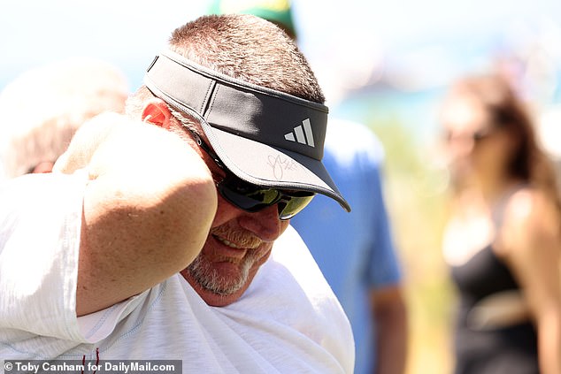The fan, curiously named as Rich Backeneck, was spotted clutching his neck with a grimace