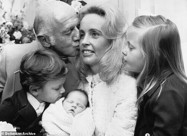 Sonia and her husband are pictured with their three children - Julian, Deborah and Melinda