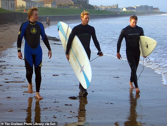 William with two St Andrews friends while surfing during a visit to a local beach
