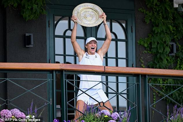 A triumphant Iga Swiatek celebrated winning the Wimbledon final as she raised the Venus Rosewater Dish on the Centre Court balcony