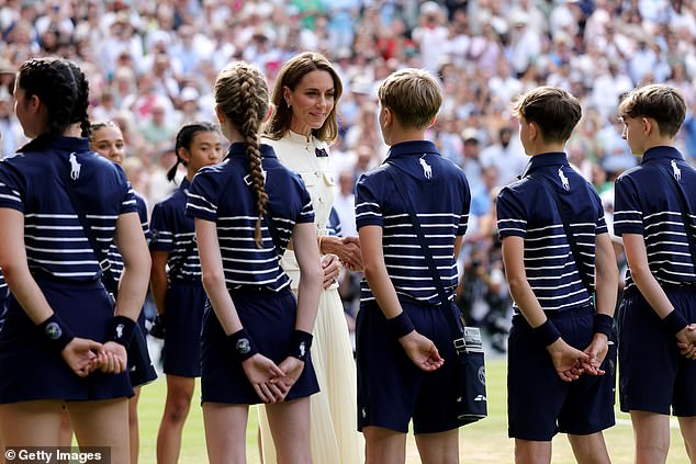 Kate, the Patron of the AELTC, talks to the ball boys and girls ahead of the trophy presentation