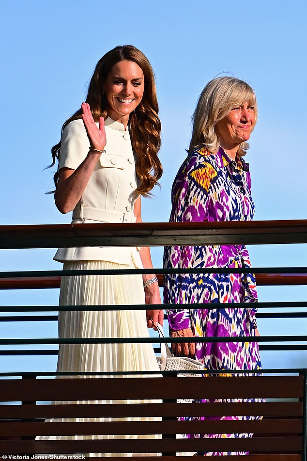 Princess Kate pictured waving to the crowds as she walks alongside chair Debbie Jevans