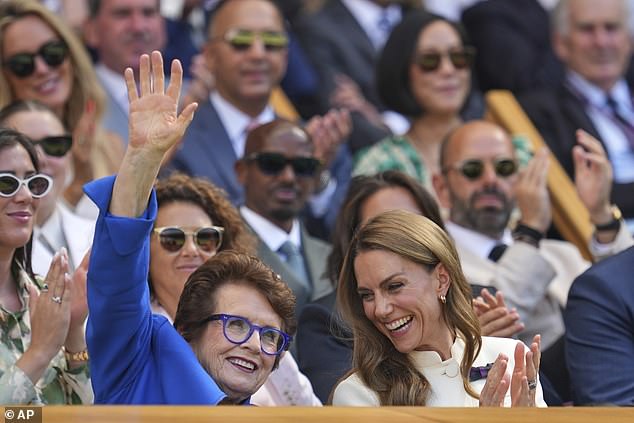 Legendary tennis player Billie Jean King waves to the crowd as Catherine smiles on