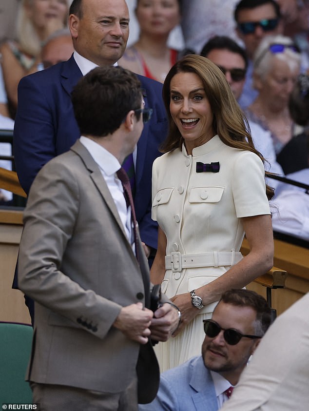 Glowing Catherine appears thrilled to see one spectator as she prepares to take her seat