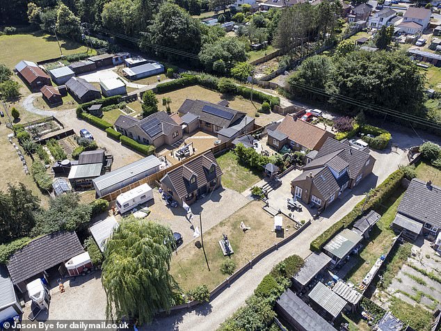 MailOnline spoke to neighbours near the property (pictured, the house, centre right, and the annex, centre left), which sits on a quiet gravel lane off a main road on the outskirts of Norwich - and they are deeply divided about it