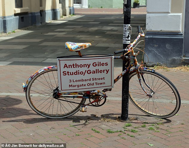 An artist advertises their new gallery in Margate's trendy old town