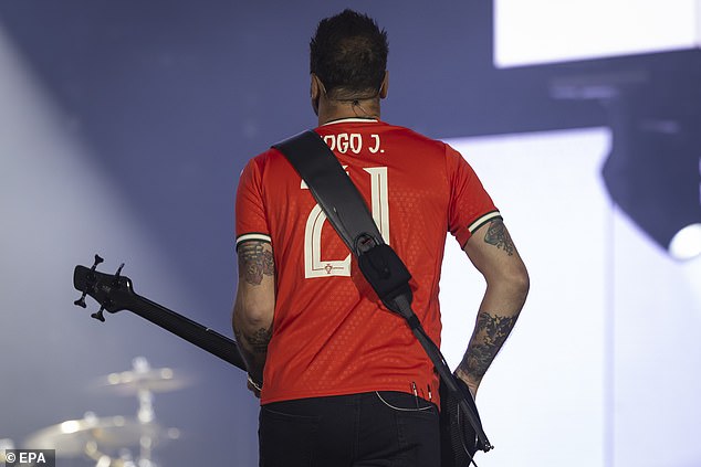 Guitarist Chris, 46, sported Portugal's national football strip for the set, and before the encore, turned around to reveal Diogo Jota's name and number, 21, on the back