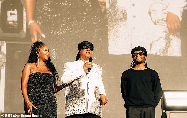 Arriving on stage, the legendary musician, 75, was dressed in a white tunic with stitched portraits of John and Marvin on either side