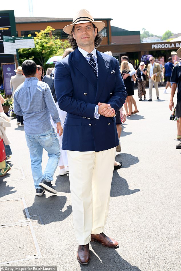 While fellow movie star Henry put on a very dapper display at the championship, waring a navy blue double breasted blazer and cream trousers