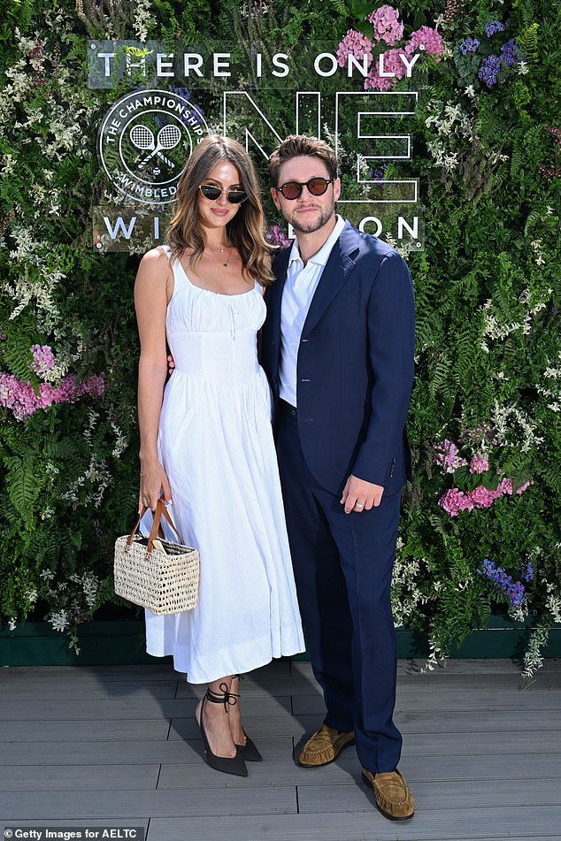 The One Direction singer was typically handsome in a dark blue suit, while Amelia nailed summer chic in a simple white milkmaid style dress
