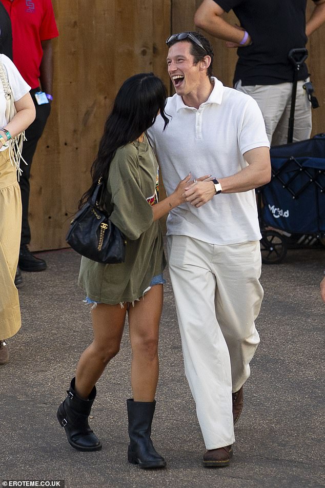 Appearing in a playful mood, the pair held hands while walking through the festival before they embraced for a hug