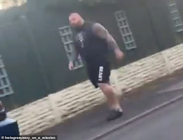 Hall appeared incensed by something the driver of a blue BMW said to him as it pulled away