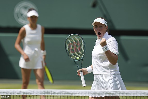 Su-Wei Hsieh of Taiwan and Latvia's Jelena Ostapenko, right, celebrate after winning a point against Russia's Veronika Kudermetova and Elise Mertens of Belgium during the women's doubles final at the Wimbledon Tennis Championships in London, Sunday, July 13, 2025. (AP Photo/Kin Cheung)