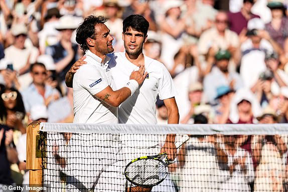 LONDON, ENGLAND - JUNE 30: Carlos Alcaraz (R) of Spain greets Fabio Fognini of Italy after their Gentlemen's Singles First Round match on day one of The Championships Wimbledon 2025 at All England Lawn Tennis and Croquet Club on June 30, 2025 in London, England. (Photo by Shi Tang/Getty Images)