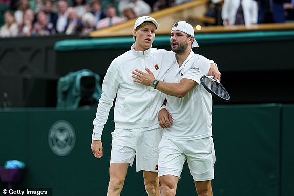 LONDON, ENGLAND - JULY 07: Jannik Sinner (L) of Italy greets Grigor Dimitrov of Bulgaria after Dimitrov retired due to injury in the Gentlemen's Singles Fourth Round match on day eight of The Championships Wimbledon 2025 at All England Lawn Tennis and Croquet Club on July 07, 2025 in London, England. (Photo by Shi Tang/Getty Images)