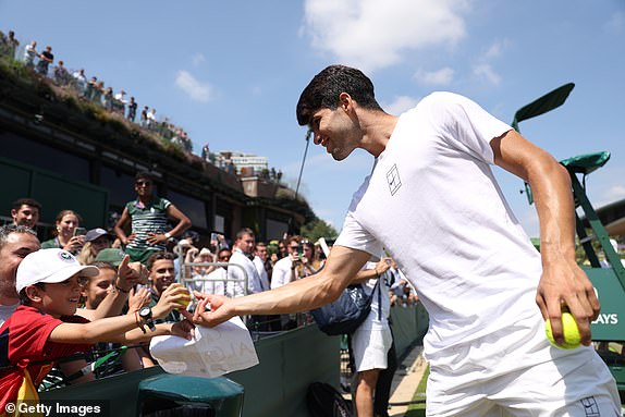 LONDON, ENGLAND - JULY 13: Carlos Alcaraz of Spain gives tennis balls to fans in a practice session prior to the Gentleman's Singles Final against Jannik Sinner of Italy on day fourteen of The Championships Wimbledon 2025 at All England Lawn Tennis and Croquet Club on July 13, 2025 in London, England. (Photo by Clive Brunskill/Getty Images)