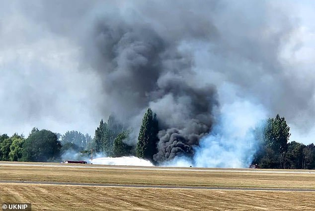 A huge cloud of black smoke was seen billowing from the side of the runway