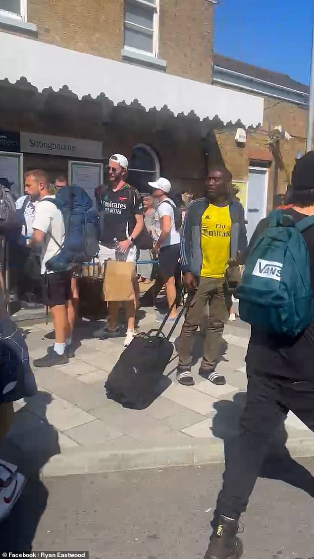 Stranded passengers carry their luggage with them in the brutal weather conditions