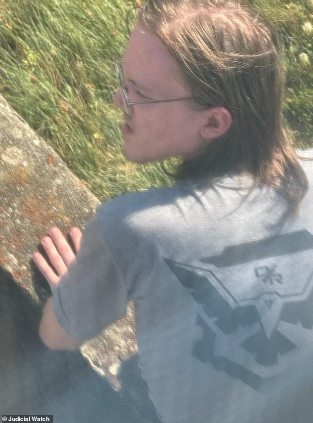 Cell phone video taken the day of the assassination attempt shows a long-haired Crooks lurking around the rally site waring a gray t-shirt with the logo of Demolition Ranch, which is a popular YouTube channel known for its firearms and demolition content