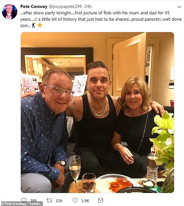 Robbie poses with his divorced parents Pete and Janet after his gig in Las Vegas