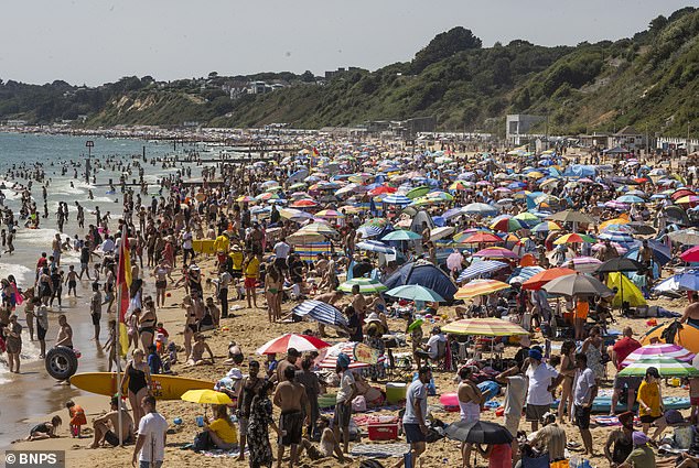 Britain's third heatwave is set to come to a close tomorrow, with heavy and thundery downpours bringing cooler temperatures after the hottest day of the year (Pictured: visitors and locals flocked to a packed Bournemouth Beach on July 13, 2025)