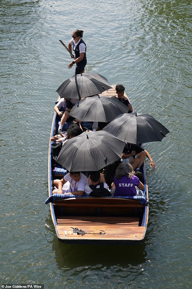 CAMBRIDGE: People punting along the River Cam used umbrellas to shield themselves from the scorching sun