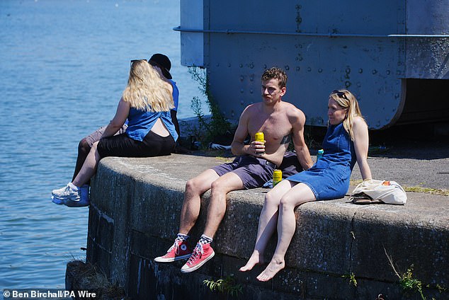BRISTOL: People enjoy the hot weather with a drink by the water