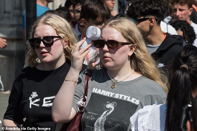 LONDON: A woman uses a hand-held fan in a desperate bid to cool down on July 13, 2025