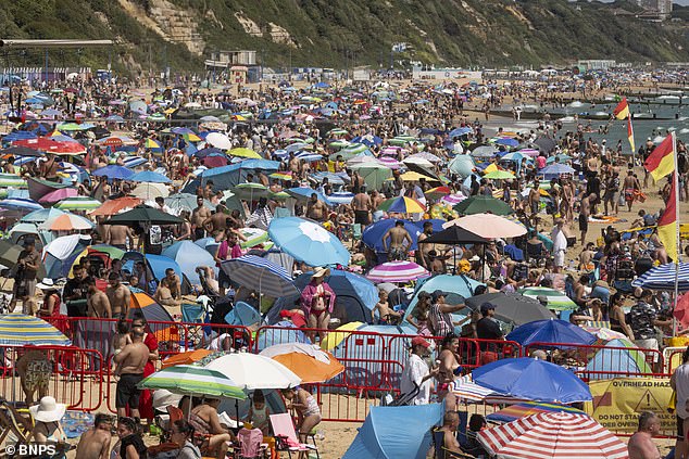 DORSET: Umbrellas lined Bournemouth beach as people looked to take advantage of the sunny weather on July 13, 2025
