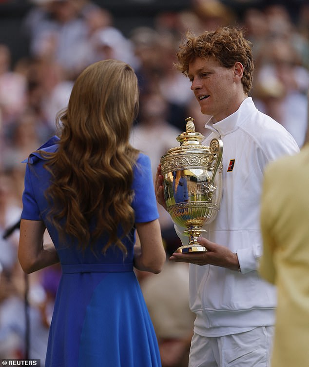 Kate, who is patron of the All England Club, hands the trophy to Sinner