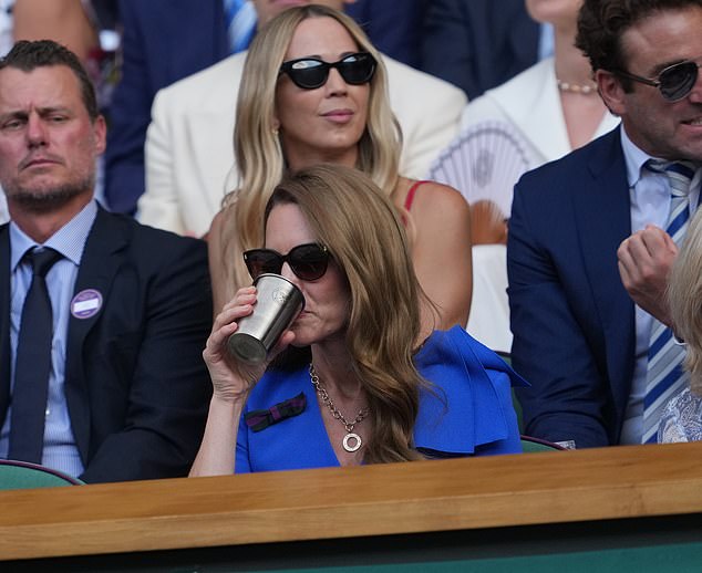 The Princess sips a drink in the cool weather as she settles down to watch the Wimbledon final this afternoon