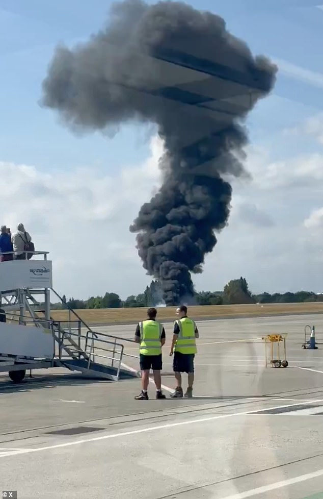 In one video circulating online, passengers were seen boarding with the crash billowing smoke on the other side of the runway