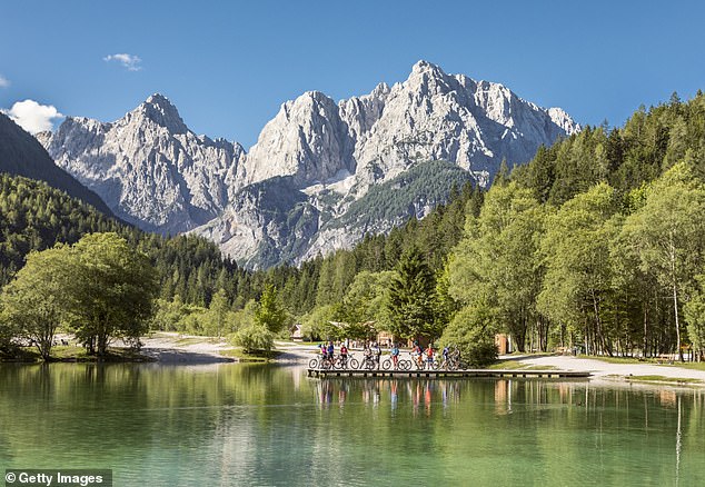 Lake Jasna, in front of the Julian Alps mountain range, lies near the village of Kranjska Gora