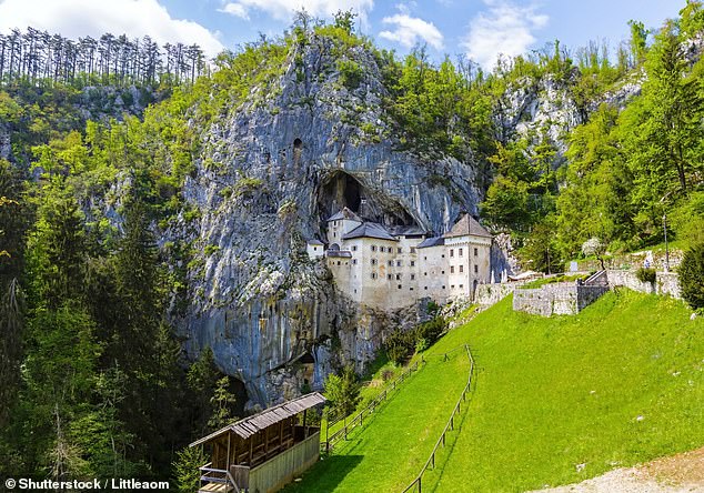 Predjama Castle, set into the mountainside, is a few miles away from Postojna