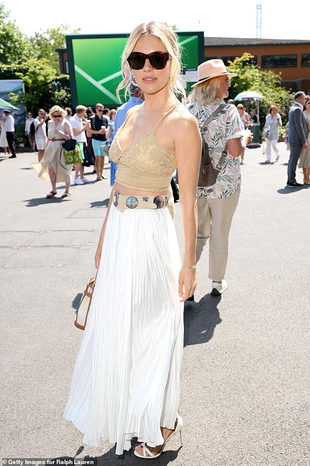 Sienna teamed her top with a pleated white maxi skirt and showed off her bohemian style by adding a chunky Western-style belt covered in engraved silver buckles