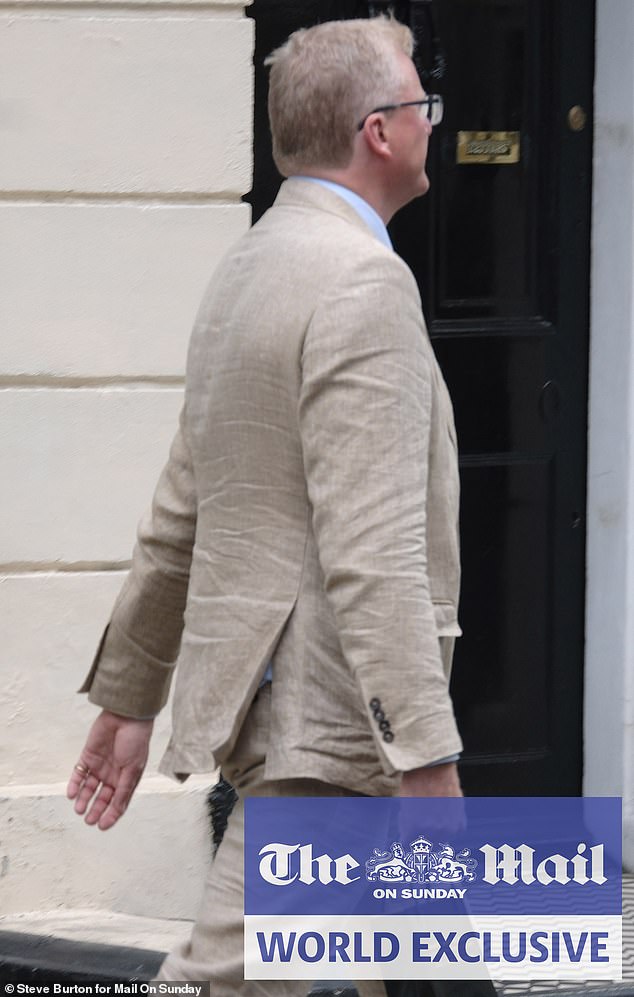 Tobyn Andrea arrives for the secret meeting - turning up minutes after Ms Maines with a gift from Berry Bros & Rudd