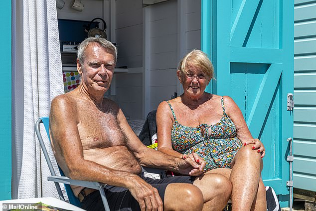 A short walk past some more piles of rubbish, Ros and Terry Keenan are soaking in some afternoon sun