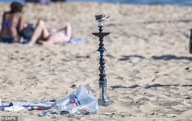 A bong stands embedded in the golden sands of Bournemouth beach like King Arthur's Excalibur in May