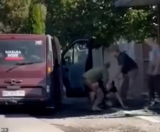A band of press-gangers are seen wrestling a man and trying to force him into a van