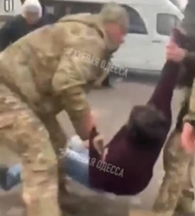 A man is dragged into a van by press gangers in Odessa