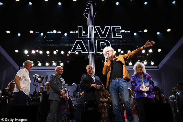 John Kennedy, Midge Ure, Harvey Goldsmith, Bob Geldof and Brian May on stage during the curtain call