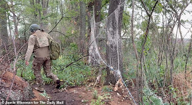 Along the frontline, netting is used as a flimsy protection against the enemy's drones