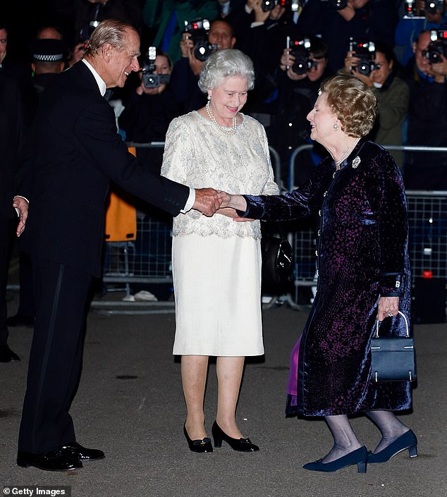 Thatcher shakes hands with Prince Philip and curtsy for the Queen as she greets them outside her 70th birthday party