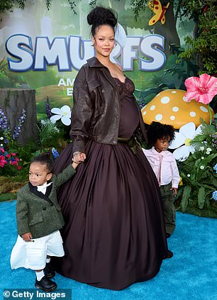 The Fenty Beauty founder flashed a small smile during the brief photo session - and posed for more sweet snaps with her two sons