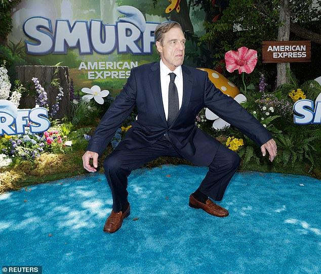 He paused for a brief photo session upon arriving to the Paramount Theater and at one point, struck a humorous pose for the cameras