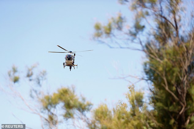 Firefighters from the GRAE team, which specialises in special operations, search for the two possible missing people, over Cubelles, on Sunday