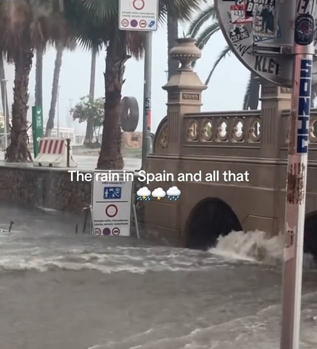 Water gushes underneath a bridge in Spain amid extreme floods and thunderstorms