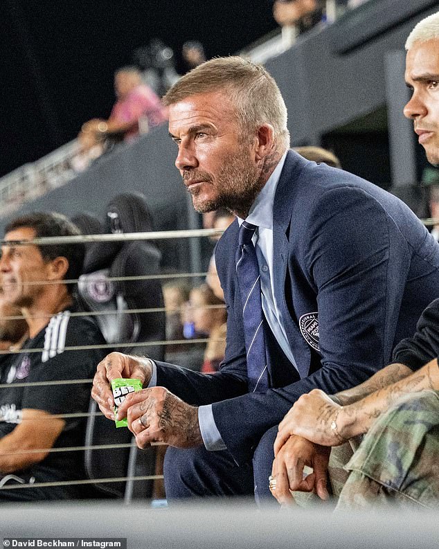 The former footballer, 50, was busy promoting the snack brand BEEUP as he watched his team Inter Miami play alongside Romeo, 22