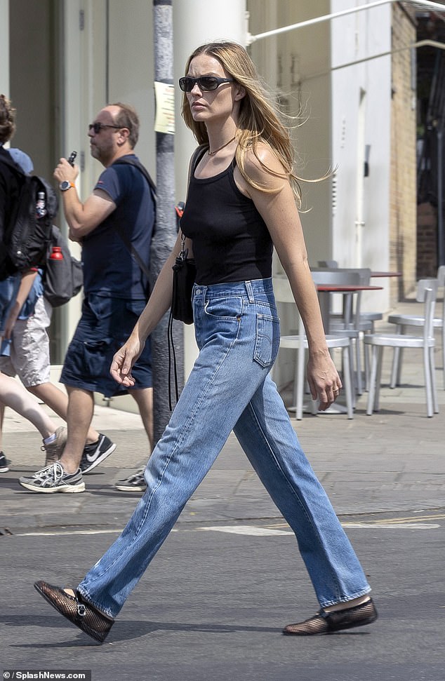 She completed her look with a pair of £650 Alaia mesh sandals while heading off for a shopping trip