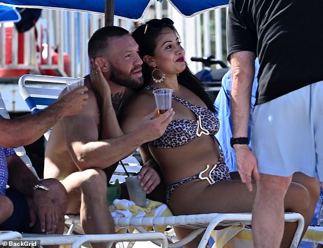 The Irish MMA star packed on the PDA with the bikini-clad woman as they smooched in full view of other beachgoers